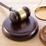 high angle shot gavel scale wooden surface 300x200.jpg